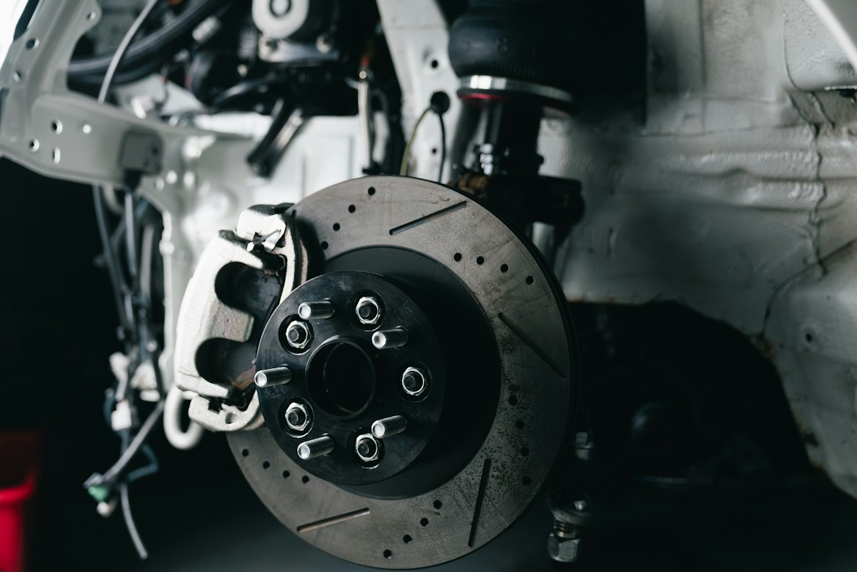 Red performance brake caliper mounted behind a wheel